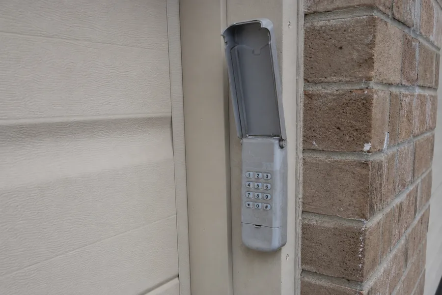 Keypad on the frame of a garage door in bright desert light
