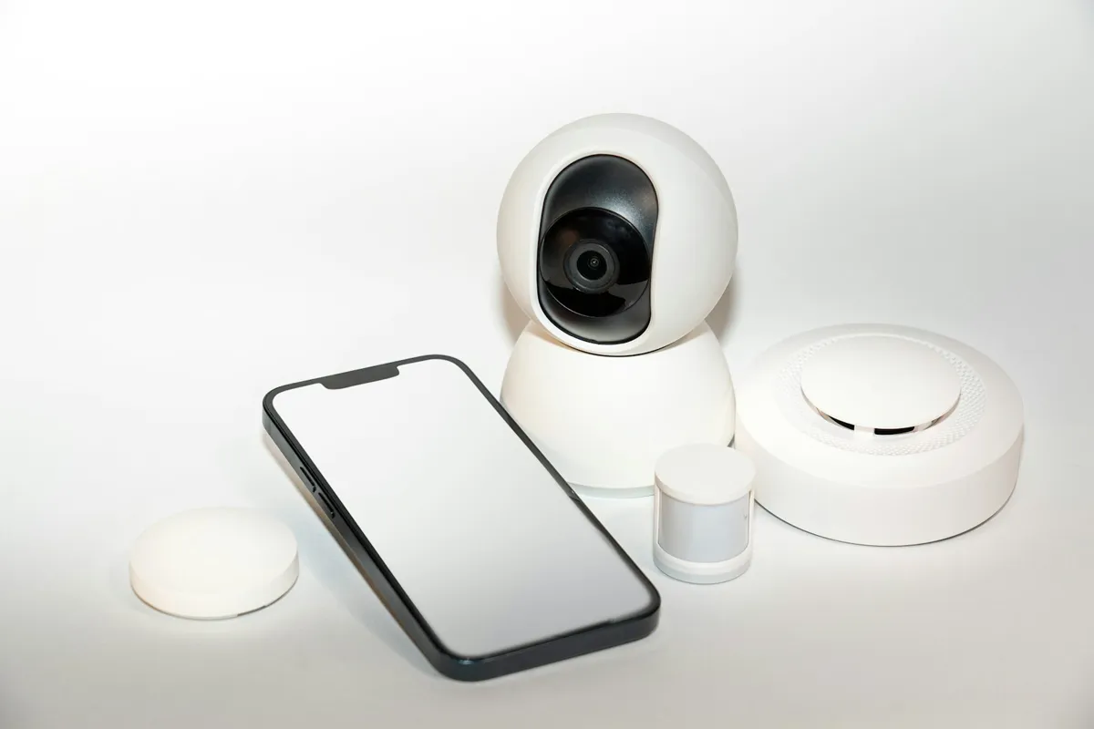 Smart camera, phone and sensors on a white surface